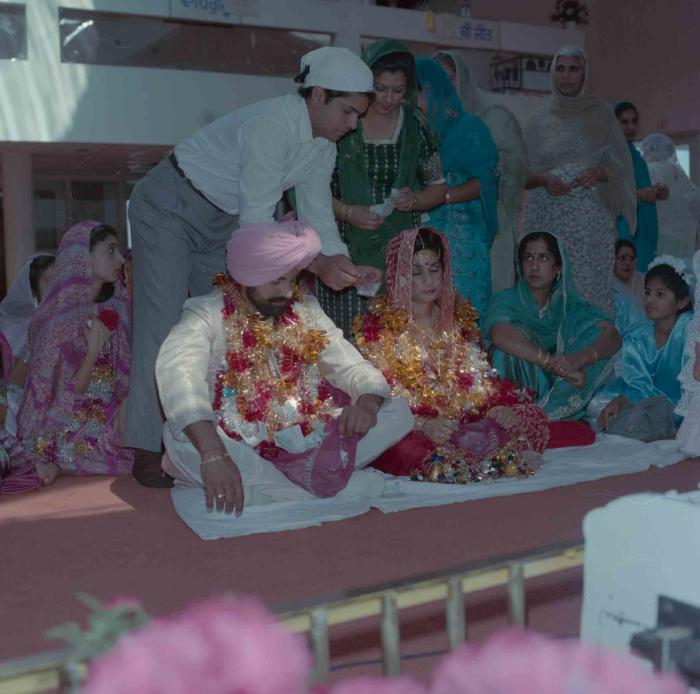 [Group photo of Nav Sunner and Parmvir Mann with wedding guests]