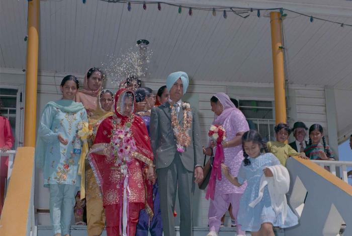 [Group photo of unidentified bride and groom with wedding guests]