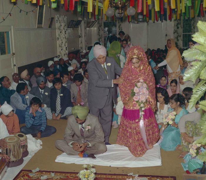 [Photo of Malkit Gill and Onkar Brar]