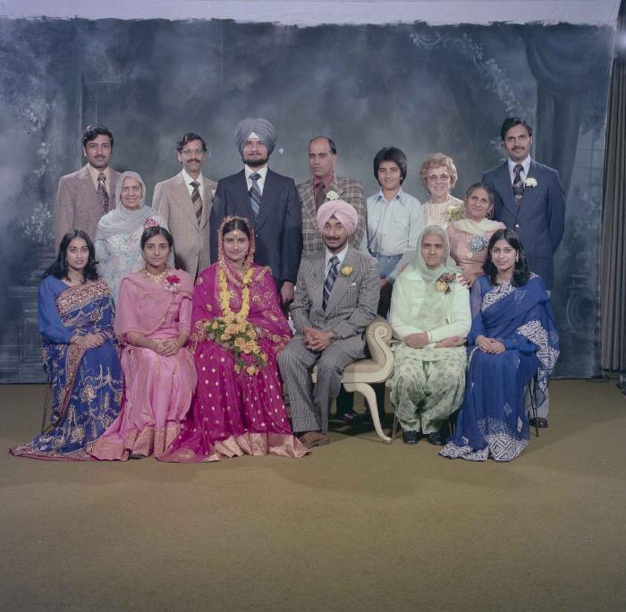 [Photo of Parminder Grewal and Joginder Thind with family members]