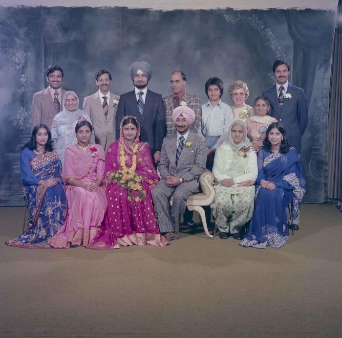 [Photo of Parminder Grewal and Joginder Thind with family members]